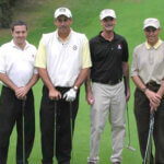 mens holding golf clubs and smiling for photo