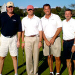 mens holding golf clubs and smiling for photo