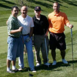 mens holding golf clubs and smiling for photo