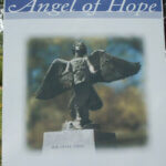 Sign that shows picture of Angel of Hope statue. Sign reads "Angel of Hope"