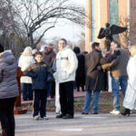 people gathered in front of Angel of Hope statue