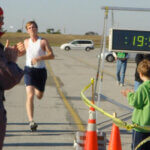 man running in front of timer