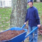 Nick doing yard work and smiling