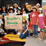 Sequoya middle school students gathered together for photo. They are holding up a sign that says "Angela's House" from the Sequoya Middle School Sachem School district.