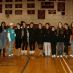 people gathered together in a gym smiling