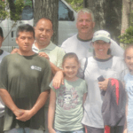 Landscaping company with individuals smiling together