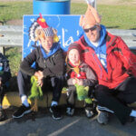 parent with children. They are wearing decorated tukey hats