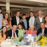 People gathered together near table smiling